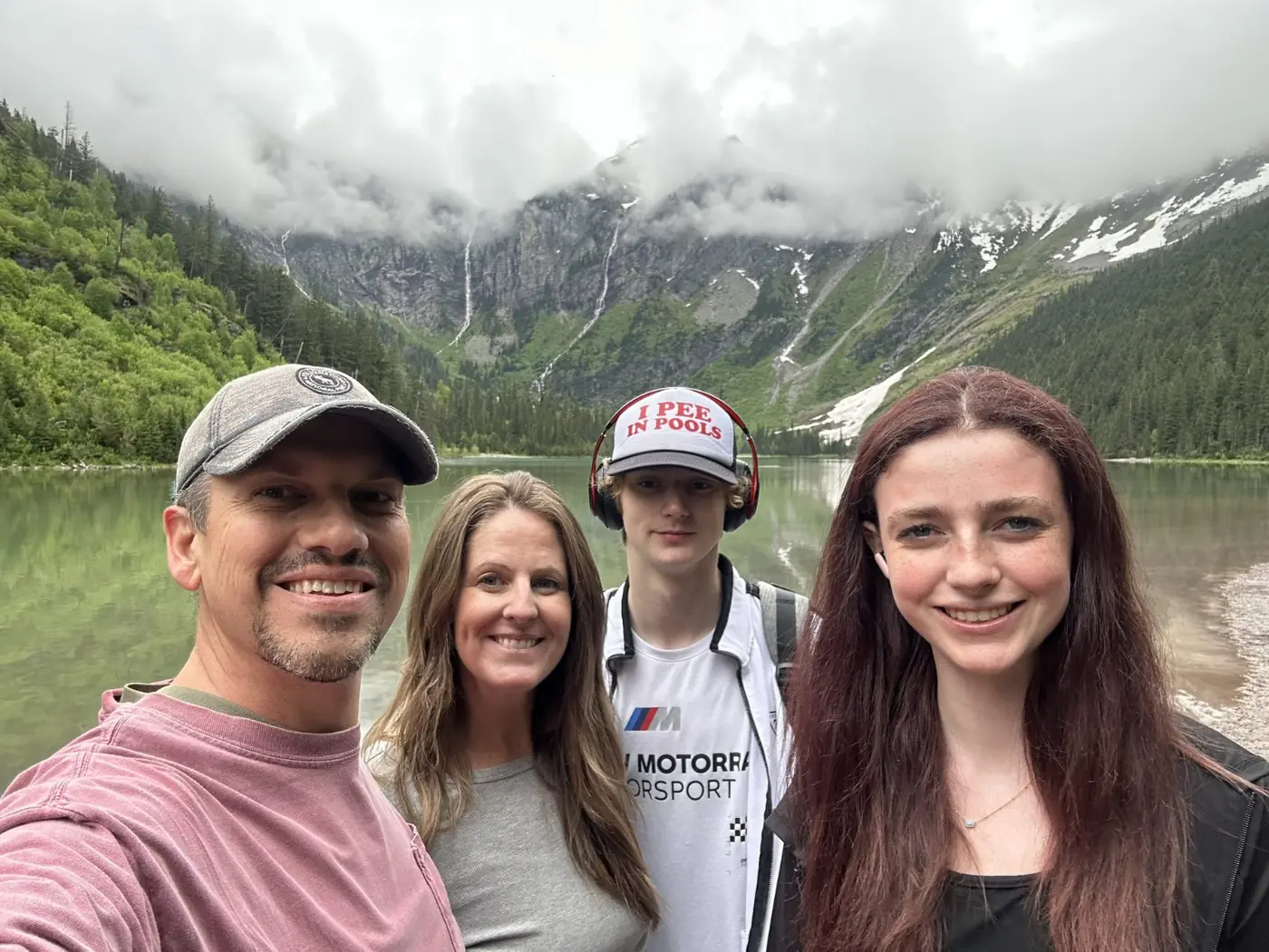 The Shannon family beside a glacial lake beneath misty mountains.